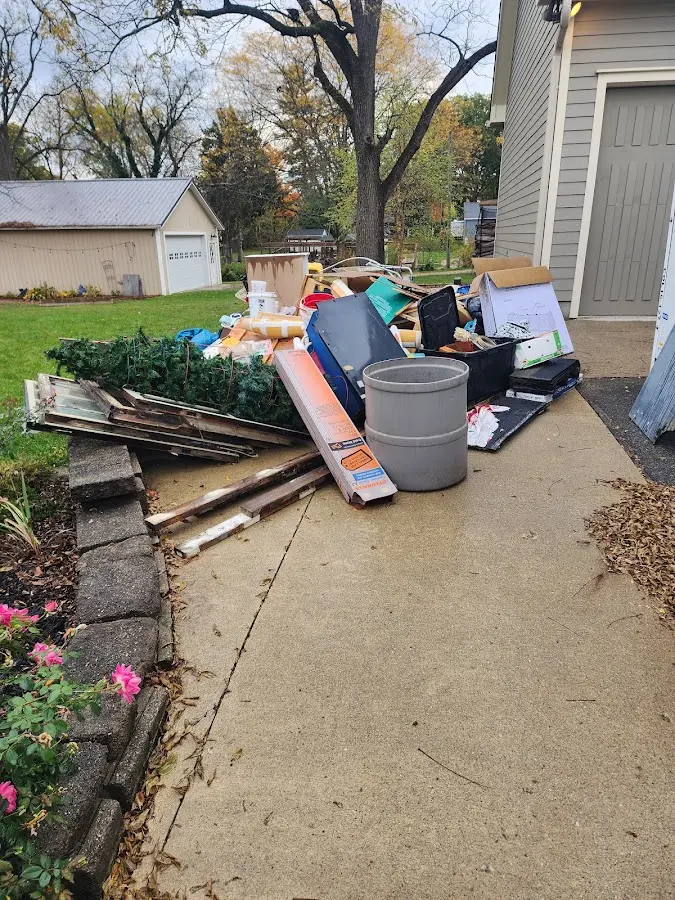 Dumpster being loaded with debris for 12 Yard Dumpster Rental in Lehigh Acres